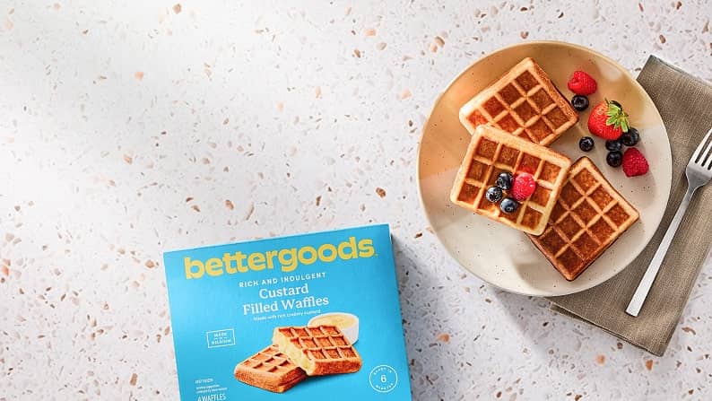 bettergoods custard-filled waffles are stacked on a plate with fresh berries for garnish.