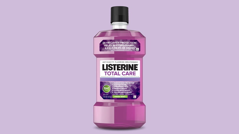 Listerine total care product on a purple background.