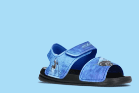 Image shows blue Monster Jam Megalodon toddler boys' single strap sandals with a shark design on a light blue background.