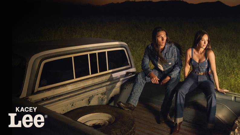 Kacey Lee logo in bottom left corner. Kacey Musgraves and a man are wearing denim outfits sitting in a truck bed at night.