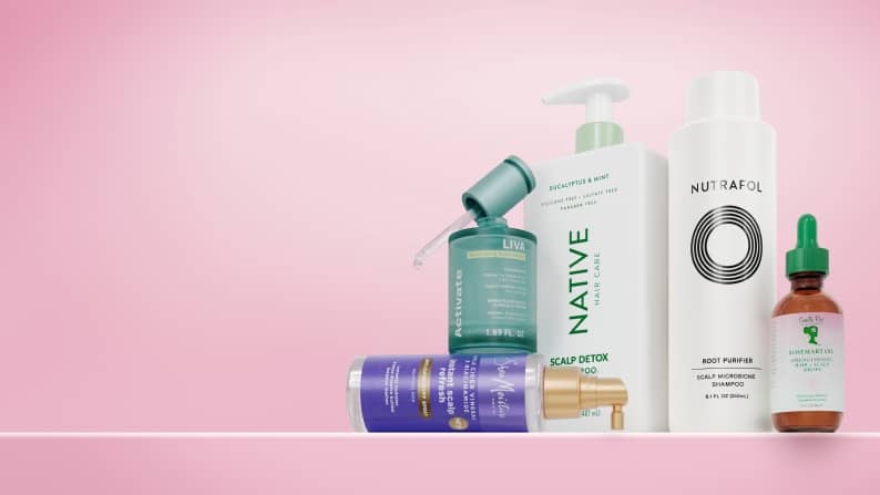 An image featuring for Native, Nutrafol & more scalp care for healthy hair with serum and shampoo bottles on pink background.