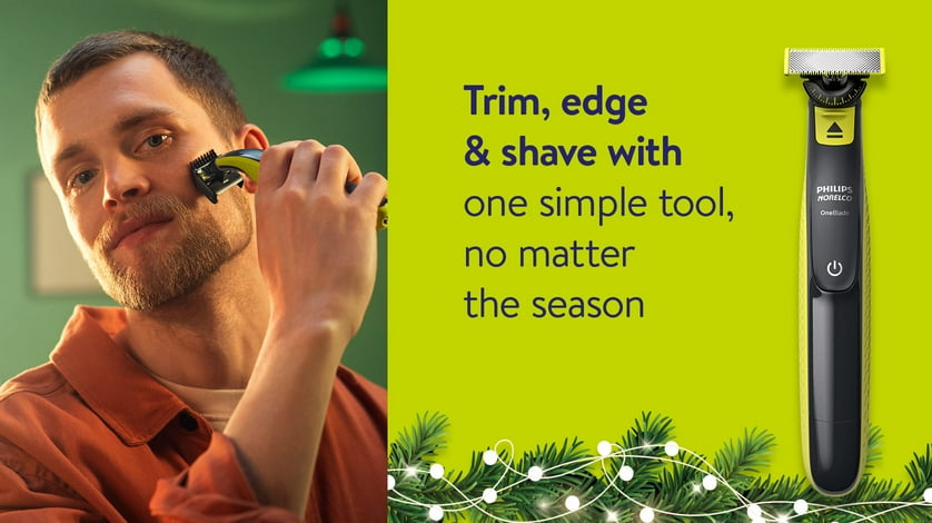 Man shaving with a Philips Norelco OneBlade, next to a picture of the product over a holiday background.