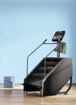 A step machine against a blue wall.