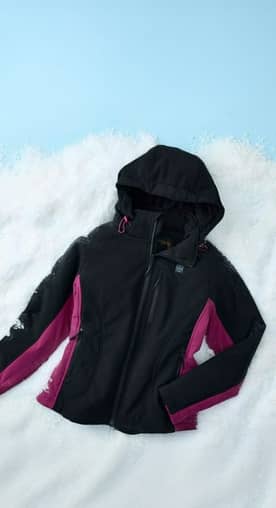 A women’s black and pink heated jacket with detachable hood is shown against a snowy background.