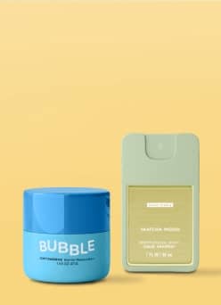 Bubble Barrier Restore Balm and Scent Theory hand sanitizer on yellow background.