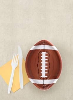Image shows a football shaped plate and disposable forks and knives.