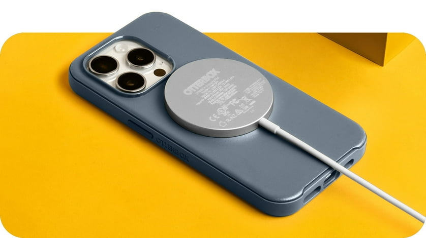An OtterBox wireless charger charges a smartphone.