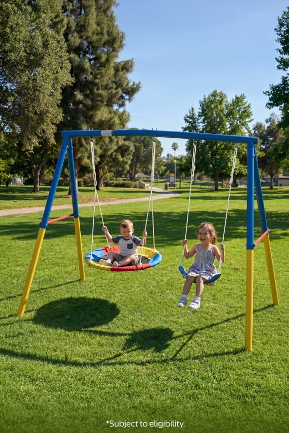 Walmart Plus. Subject to eligibility. Two children sit on swings on a colorful swingset in a sunny park.
