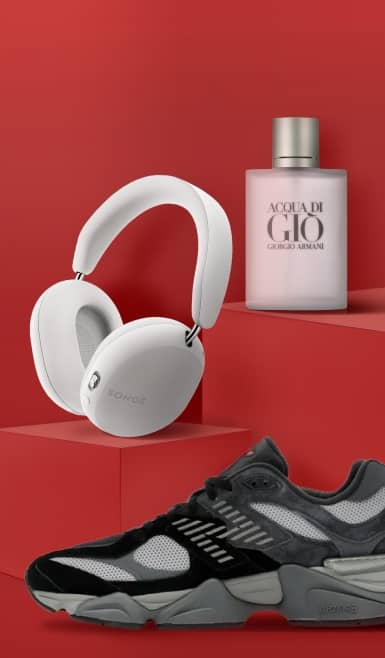 View white Sonos headphones, black and gray New Balance sneaker and a pink bottle of Giorgio Armani perfume.