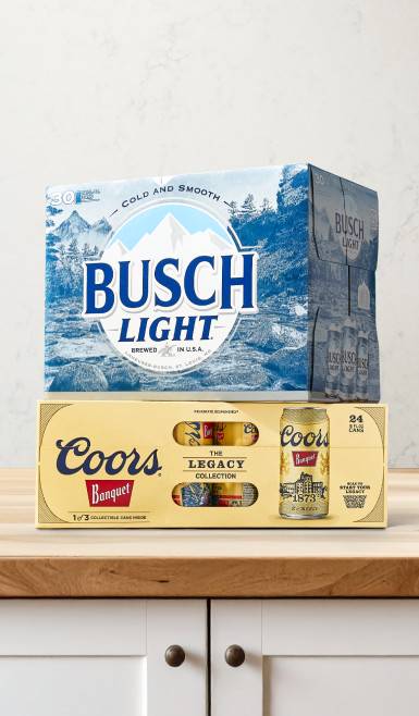 A pack of Busch Light is shown stacked on top of a pack of Coors Legacy.