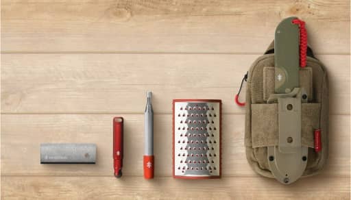 Survival kit on wooden background.
