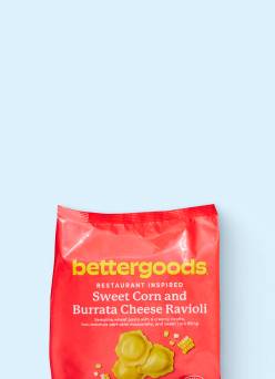 A bag of bettergoods frozen sweet corn and burrata cheese ravioli against a ligt blue background.