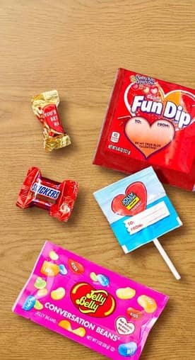 Mini chocolates are shown with Valentine’s Fun Dip, a heart-shaped lollipop and conversation Jelly Beans.