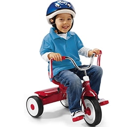 Young boy wearing a helmet riding a red kids' tricycle