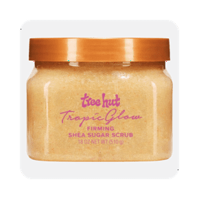 Image shows an orange Tree Hut Tropic Glow Firming Shea Sugar Body Scrub jar with a white lid, containing eighteen ounces of product.