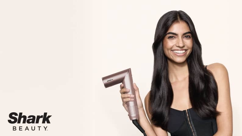 An image of a model on the right-side holding a hair tool and the Shark Beauty logo at the bottom left.