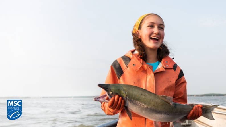 A fisherman holding a fresh-caught fish is shown. A logo for the Marine Stewardship Council is in the bottom left corner.