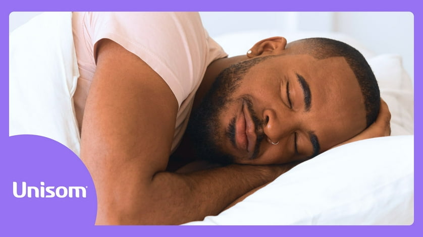 A person resting their head against a white pillow.