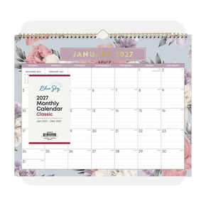 Image shows a Blue Sky twenty twenty-seven monthly wall calendar featuring a floral design and gold binding, hung against a white background.
