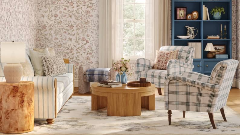 A blue-striped sofa, plaid armchairs, and wood accents in a room with floral wallpaper. Reads: Max out on prints from twelve eighty-eight.
