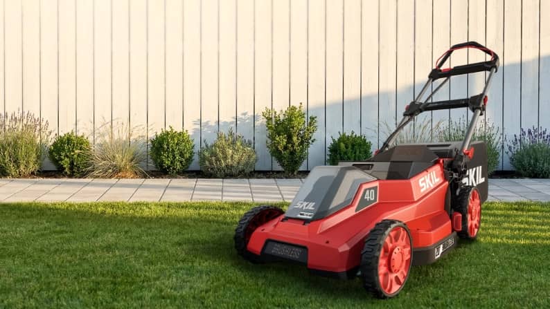 SKIL lawn mower in a yard.