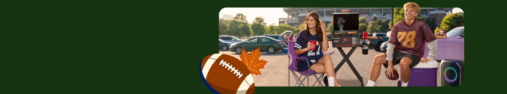 Two people sat in a parking lot stadium wearing jerseys. A grill, cooler, speaker, table with food.