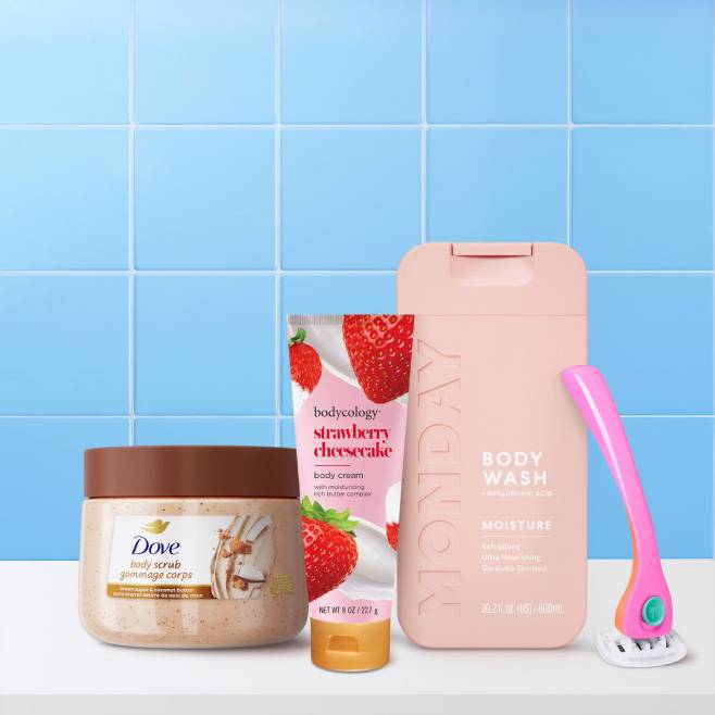 Dove body scrub, Bodycology Strawberry Cheesecake body cream, MONDAY body wash, and a pink women’s razor.