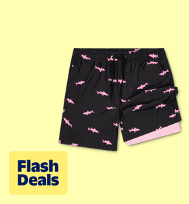 Flash deals. Image shows black Dakimoe men's swim trunks with pink shark prints on a light yellow background.