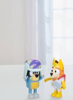 Two figurines on a grey background. Text says: All about Bluey. Join the pack for new adventures.