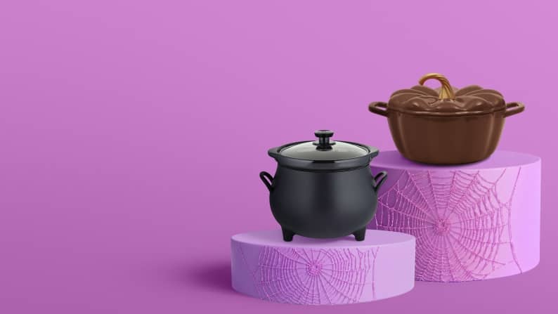 A black cauldron pot and a brown pumpkin-shaped Dutch oven sit on purple pedestals.
