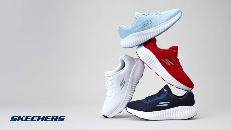 Four single Skechers slip-on lace-up sneakers are shown. One white, one red, one baby blue and one navy blue.