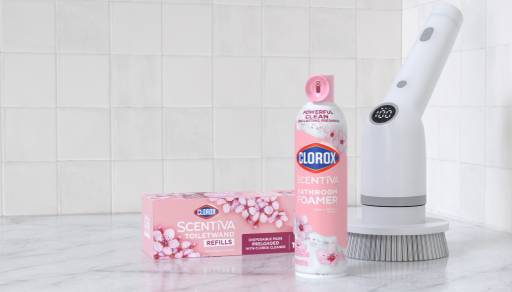 Cleaning products and tools in a white bathroom setting.