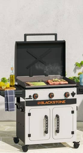 Blackstone griddle with food cooking on it.