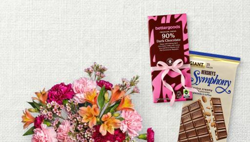 A colorful bouquet of fresh flowers, a bettergoods premium Swiss 90 percent dark chocolate bar, and a giant Hershey’s Symphony bar.