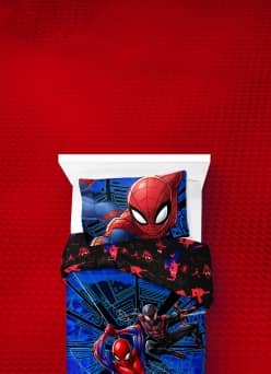 A twin bed featuring the Marvel Spiderman blue reversible twin bedding set.