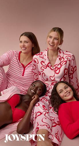 Four women in PJs—one in a striped set, one in red top and patterned shorts, one in pink set with red bra, and one in pink and red patterned set.