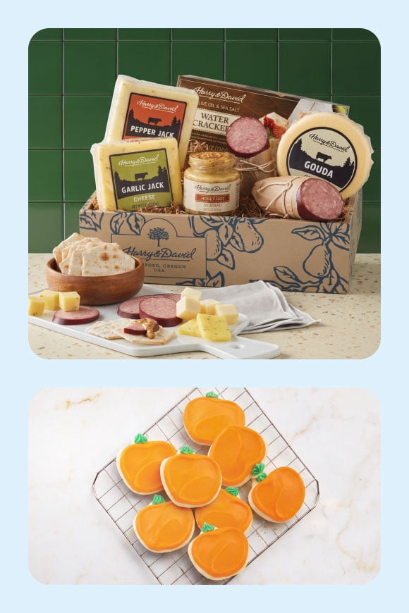 Harry and David gift box with assorted cheeses, sausage, crackers and mustard, plus orange frosted fruit shaped cookies on a cooling rack.