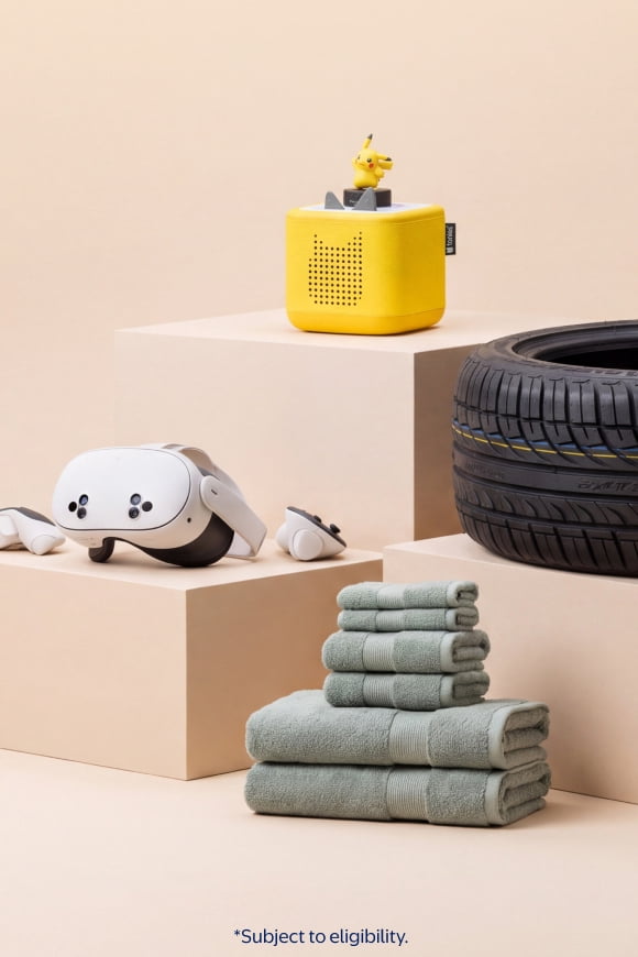 Subject to eligibility. A virtual reality headset, folded green towels, a yellow speaker with toy figure and a car tire on pedestals.