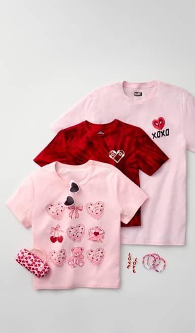 Pink and red printed tees, heart-shape sunglasses are layered with pink and red jewelry.