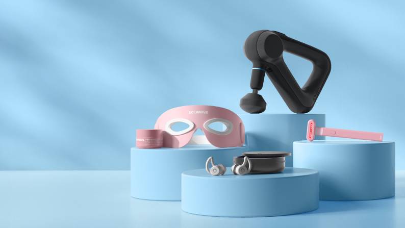 Pot of Solawave face cream, Solawave LED eye mask, earbuds with case, handheld massager and LED wand.