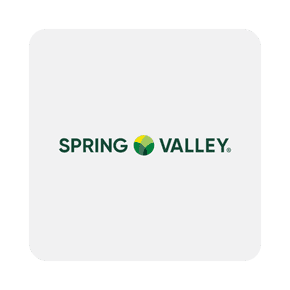 Image shows Spring Valley logo on a light gray background with green text and a circular green and yellow emblem between the words.