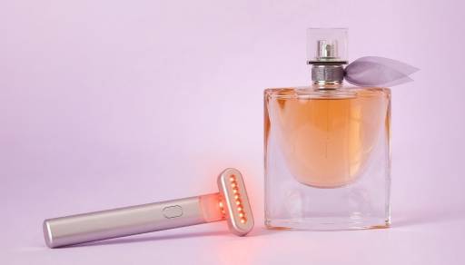 Bottle of perfume and Solawave wand.