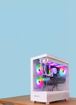 White gaming desktop PC tower with RGB lighting on a wooden surface.