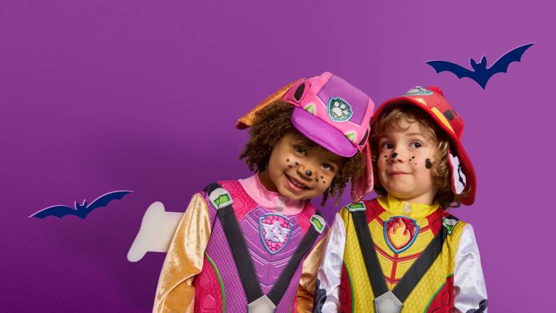 Two children in Paw Patrol themed costumes.