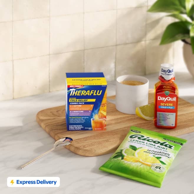 Express Delivery badge with Theraflu, DayQuil Severe and Ricola lemon lime mint cold and flu products on a kitchen counter.