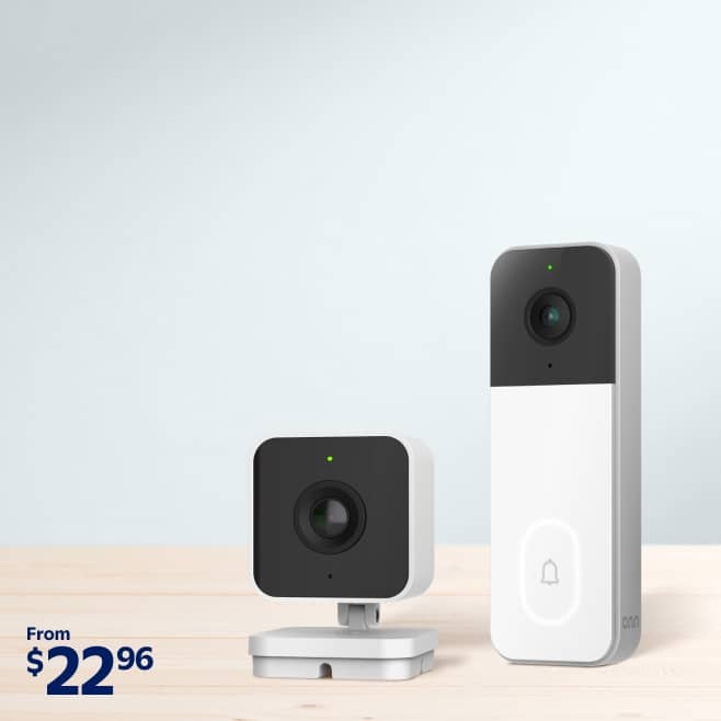 Onn brand home security camera and doorbell displayed on a wooden countertop.