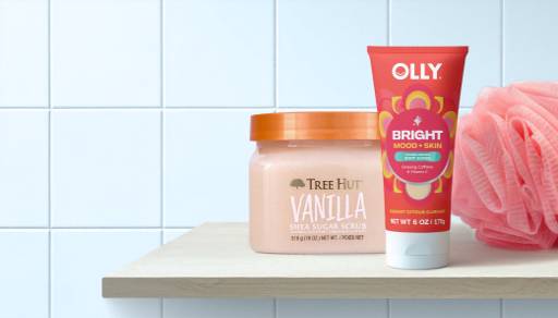 Tree Hut Vanilla Shea Sugar Scrub, an OLLY body cleanser, and a pink mesh loofah set.