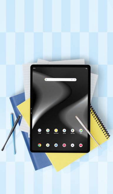 A tablet showing apps, resting on notepads.