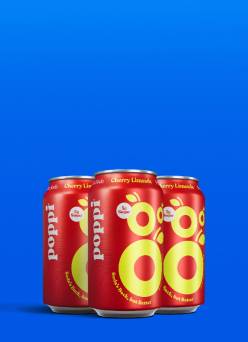 Image shows three cans of Cherry Limeade Poppi.