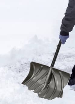 Man shoveling snow with a shovel.